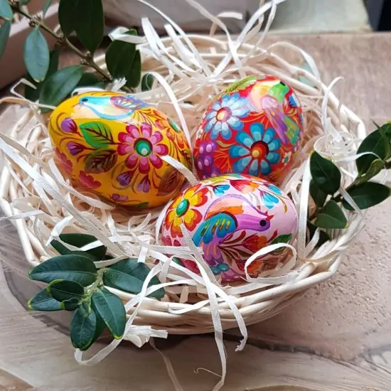 Creative Easter eggs Ukrainian painted in a basket - wooden Easter decorations