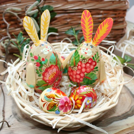 Easter basket with funny Easter rabbits and 3 small Easter eggs made of wood