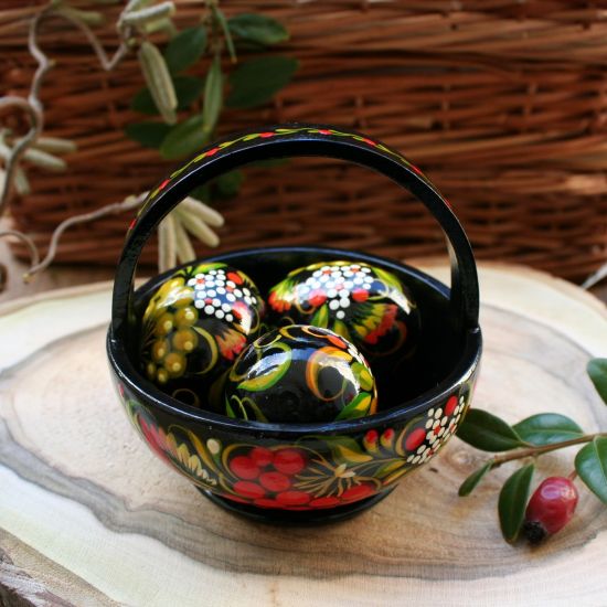 Traditional painted Easter eggs in a small wooden basket