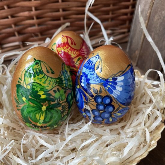 Creative Easter eggs Ukrainian painted in a basket - wooden Easter decorations