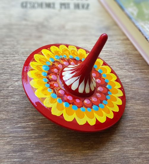 Spinning top, traditional wooden toy with geometric ornament, hand painted
