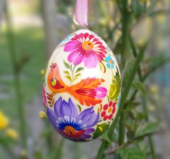 Wooden Easter egg with flowers and bird designed in Ukraine