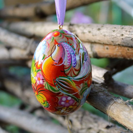 Wooden painted Ukrainian Easter egg with the pretty bird